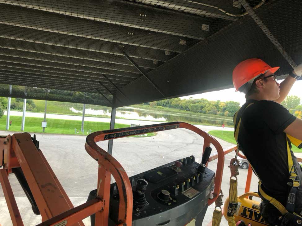 Bird Exclusion Tech Installing Netting